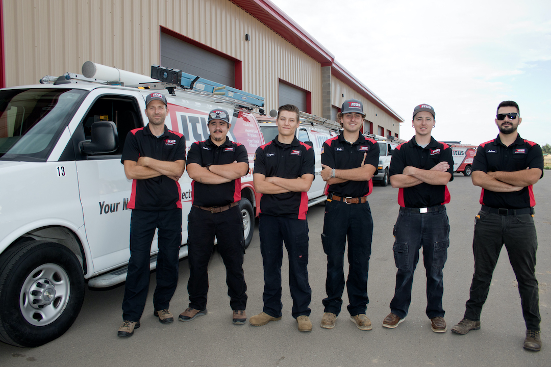 Titus workers standing in front of a Titus truck